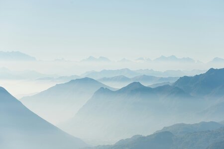 Mountains covered with a haze of blue fog.