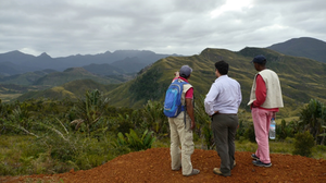 Three people looking at hilly landscape in Madagascar