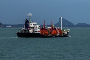 Gas tanker ship in front of shoreline 