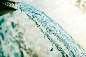 Close-up of clean water pouring from a spout